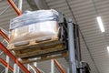 forklift loader loading cargo to warehouse shelves Royalty Free Stock Photo