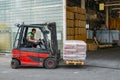 Forklift loader pallet stacker truck at small warehouse Royalty Free Stock Photo