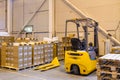 Forklift loader parking at logistics warehouse. Pallet stacker truck equipment inside of a modern warehouse storage