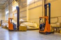 Forklift loader parking at logistics warehouse. Pallet stacker truck equipment inside of a modern warehouse storage