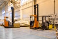 Forklift loader parking at logistics warehouse. Pallet stacker truck equipment inside of a modern warehouse storage