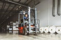 Forklift loader for warehouse works outdoors with risen forks