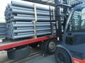 Forklift loading a truck with Plastic drain pipes pvc Royalty Free Stock Photo