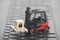 Forklift with lock graphic on wooden block over laptop keyboard Royalty Free Stock Photo