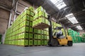 Forklift Transports Eco-Labeled Boxes in Green Warehouse While Enhancing Sustainable Logistics Practices Generative AI Royalty Free Stock Photo