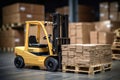 A forklift is parked in the foreground with a stack of boxes visible in the background, Forklift stuffing-unstuffing pallets of Royalty Free Stock Photo