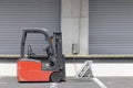 Forklift is parked in front of a warehouse in the industrial area Royalty Free Stock Photo