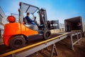 Forklift is putting cargo from warehouse to truck Royalty Free Stock Photo