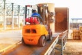 Forklift is putting cargo from warehouse to truck Royalty Free Stock Photo