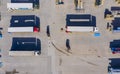 Forklift is putting cargo from warehouse to truck outdoors. Aerial. top view Royalty Free Stock Photo