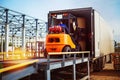 Forklift is putting cargo from warehouse to truck Royalty Free Stock Photo