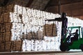 Forklift stacking up sugar bag inside warehouse, sugar warehouse operation. Agriculture product storing and logistics for import a Royalty Free Stock Photo