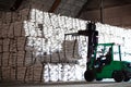 Forklift stacking up sugar bag inside warehouse, sugar warehouse operation. Agriculture product storing and logistics for import a Royalty Free Stock Photo