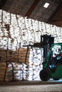 Forklift stacking up sugar bag inside warehouse, sugar warehouse operation. Agriculture product storing and logistics for import a Royalty Free Stock Photo