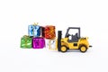 Forklift truck with colorful gift box isolate on white background, present delivery Royalty Free Stock Photo