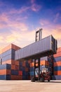 Forklift truck lifting cargo container in shipping yard Royalty Free Stock Photo