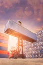 Forklift truck lifting cargo container in shipping yard Royalty Free Stock Photo