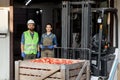 Forklift truck loading with full containers. Fruits and food distribution to market Royalty Free Stock Photo