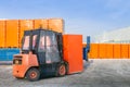 Forklift unloading truck semi trailer with wrapped cardboard boxes outdoors. openair warehouse works background