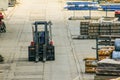 Forklift works in an open warehouse in the seaport. Royalty Free Stock Photo