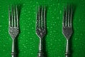 Forks in droplets of water on a colored background. Top view Royalty Free Stock Photo