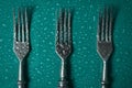 Forks in droplets of water on a colored background. Top view.l Royalty Free Stock Photo