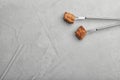 Forks with fried meat fondue pieces on grey, top view. Space for text Royalty Free Stock Photo