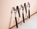 Forks standing on a wall, with big shadows between them. Royalty Free Stock Photo