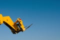 Forks of the Telescopic Forklift Telehandler raised on blue sky background Space for text