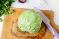 Forks young cabbage on a cutting board and knife