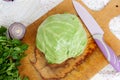 Forks young cabbage on a cutting board and knife