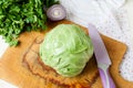 Forks young cabbage on a cutting board and knife