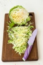 Forks young cabbage on a cutting board and knife