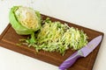 Forks young cabbage on a cutting board and knife