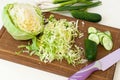 Forks young cabbage on a cutting board and knife