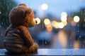 A forlorn teddy bear, rain kissed window, cocooned in bokeh warmth