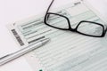 Form of income tax return with pen and glasses Royalty Free Stock Photo