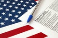 Form W-4 Employee`s withholding allowance certificate instructions and blue pen on United States flag. Internal revenue service