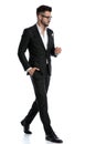 Formal businessman walking with hand in pocket and looking down Royalty Free Stock Photo