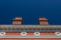 Formal centered exterior of a brick building with large chimneys and round windows, blue sky copy space Royalty Free Stock Photo