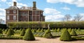 The formal Cherry Garden at Ham House, Richmond, London, with box hedges and lavender planted in a grid. Ham House in the distance