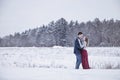 Formal couple outdoors in winter snow