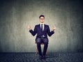 Young business man meditating on chair