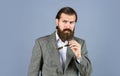 Formal fashion model. handsome man standing on gray background. serious bearded businessman. stylish mature man looking