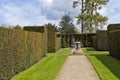 Formal garden with sundial ornament in the centre between hedge walls