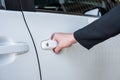 Formal hand on handle opening a car door Royalty Free Stock Photo