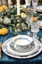 Formal holiday tablescape with blue decor, dinner table setting, table scape with elegant tableware and dinnerware for Royalty Free Stock Photo