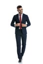 Formal man walking while closing jacket and posing cool Royalty Free Stock Photo