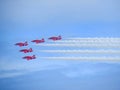 Red arrows air display with white smoke contrails Royalty Free Stock Photo