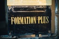 Formation Plus, More Training sign iwth golden letters